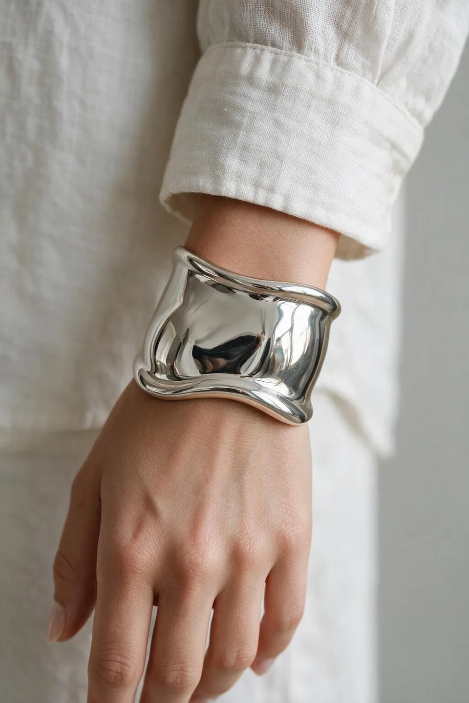 Styled editorial visualization featuring Tiffany & Co. Elsa Peretti Bone Cuff (Sterling Silver)